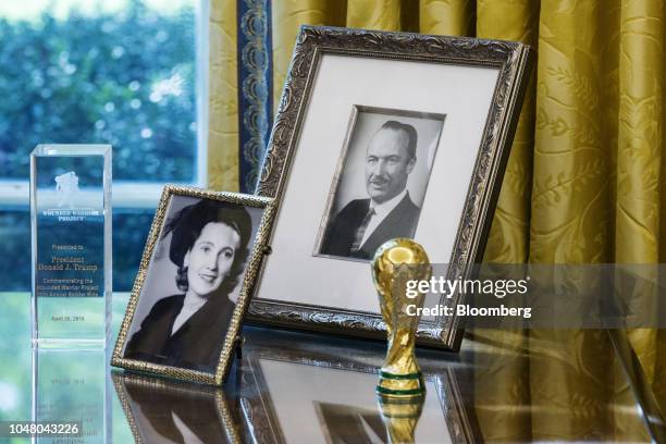 Photographs of U.S. President Donald Trump's parents, Mary Anne MacLeod Trump and Fred Trump, sit on a desk during a meeting between Donald Trump and...