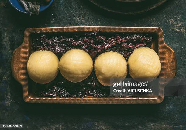 red cabbage and potato dumpling served on dark rustic background - czech culture stock pictures, royalty-free photos & images