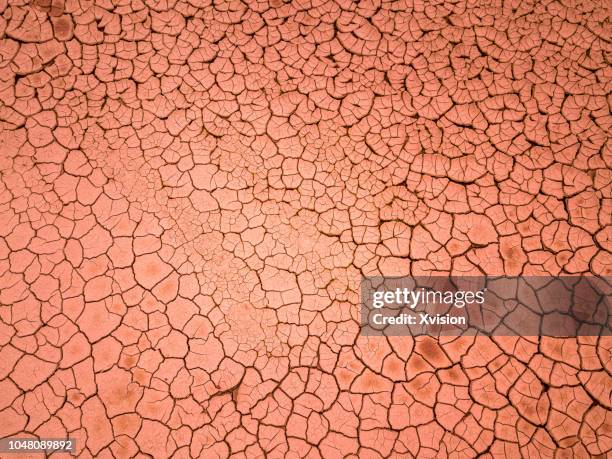 cracked red land aerial view - dry fotografías e imágenes de stock
