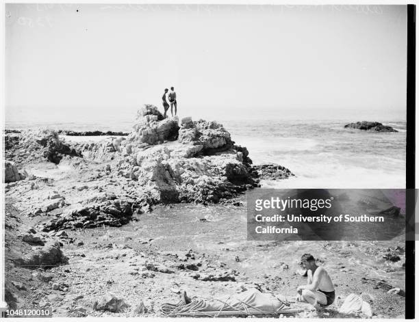 Fisherman drowns...Palos Verdes, 6 October 1951. Albert Hart beside body of unidentified fisherman who was swept off rocks and drowned while fishing....