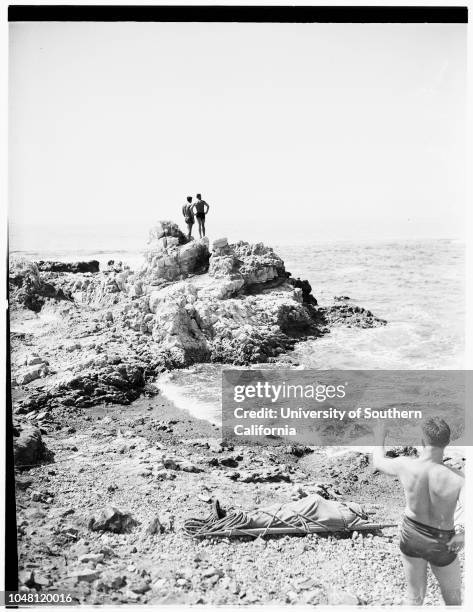 Fisherman drowns...Palos Verdes, 6 October 1951. Albert Hart beside body of unidentified fisherman who was swept off rocks and drowned while fishing....