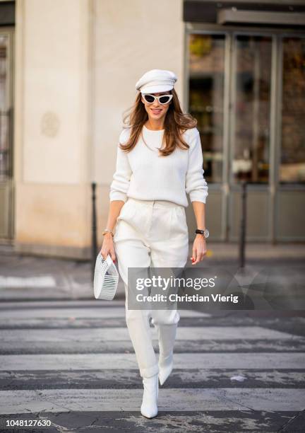 Alexandra Lapp is seen wearing white cropped trousers by Mansur Gavriel, a short knitted white pullover with a ring detail on the back from Ouì,...
