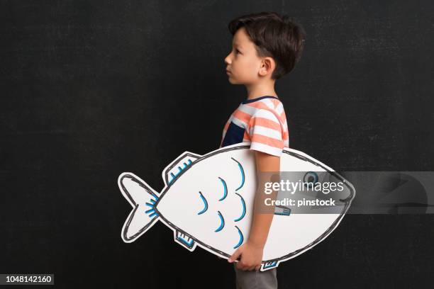 cute child holding fish drawing. - holding fish drawing stock pictures, royalty-free photos & images
