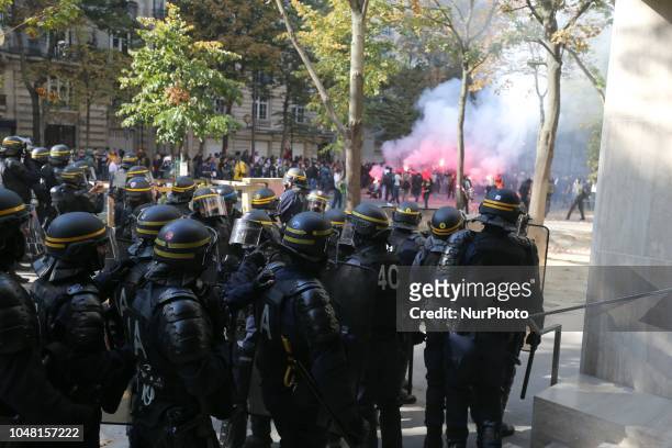 Anti riot gendarmes charge protestors during a rally called by several French workers unions on October 9, 2018 in Paris as part of a nationwide day...