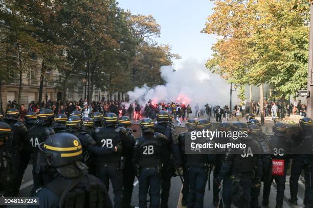 Anti riot gendarmes charge protestors during a rally called by several French workers unions on October 9, 2018 in Paris as part of a nationwide day...