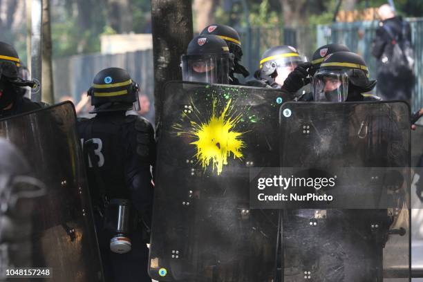 The shield of an Anti riot gendarme received a paint attack during a rally called by several French workers unions on October 9, 2018 in Paris as...