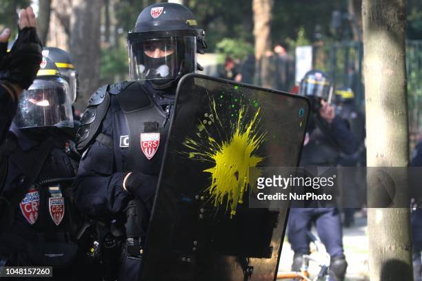 The shield of an Anti riot gendarme received a paint attack during a rally called by several French workers unions on October 9, 2018 in Paris as...