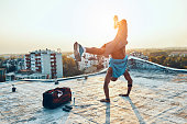 man exercising and hand standing on the rooftop