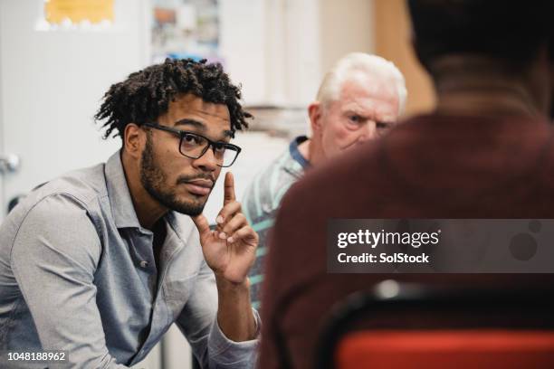 men listening in a support group - male group therapy stock pictures, royalty-free photos & images