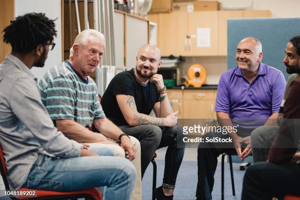 men in a support group - prop stock pictures, royalty-free photos & images