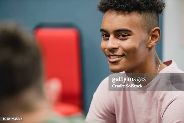 teenage students talking in lesson - teenagers only imagens e fotografias de stock