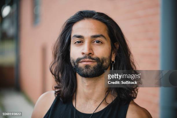 portrait of a hipster man - long hair stock pictures, royalty-free photos & images