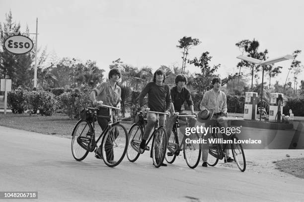 From left, Ringo Starr, John Lennon , George Harrison and Paul McCartney of the Beatles pictured together on bicycles during production and filming...