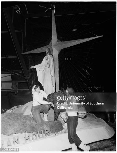 Preparation of floats for Rose Parade, 29 December 1951. Irving Yabner, wiping off elephant on South Pasadena float;Moe Bear, wiping off elephant on...