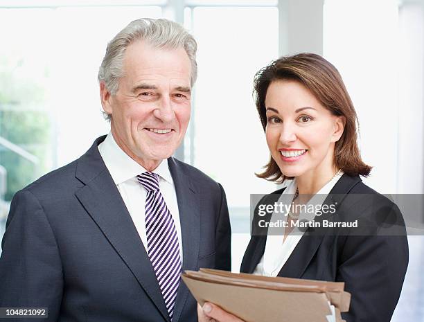 smiling business people holding files in office - female barrister uk stock pictures, royalty-free photos & images