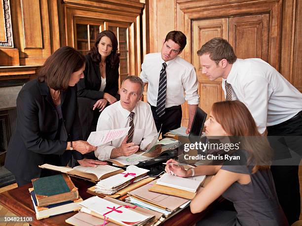 lawyers working at desk in office - legal problems stock pictures, royalty-free photos & images