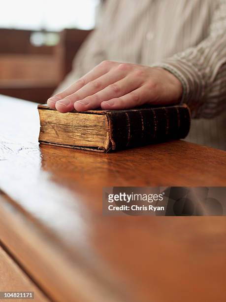 hand of witness on bible in courtroom - testimonies stock pictures, royalty-free photos & images