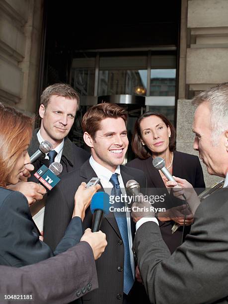 news reporters interviewing smiling man outside courthouse - england press conference stock pictures, royalty-free photos & images