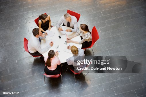 Business people having a meeting at round table Business people having a meeting at round table