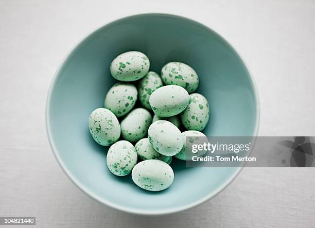 speckled blue candy eggs in bowl - easter candy stock pictures, royalty-free photos & images