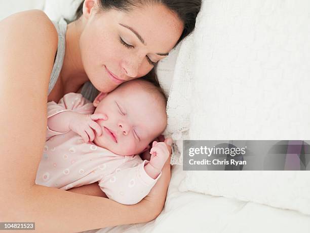 mother and baby sleeping in bed - mother sleeping baby bildbanksfoton och bilder