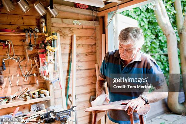 man sanding wood in workshop - shed stock pictures, royalty-free photos & images