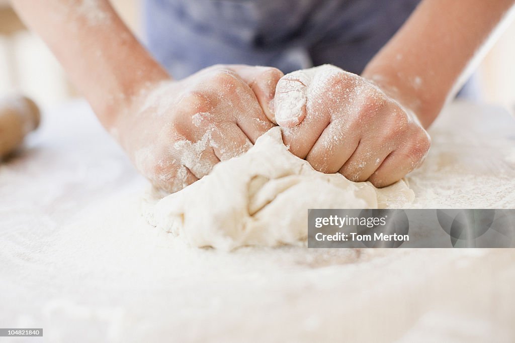 Close up of girl kneading dough