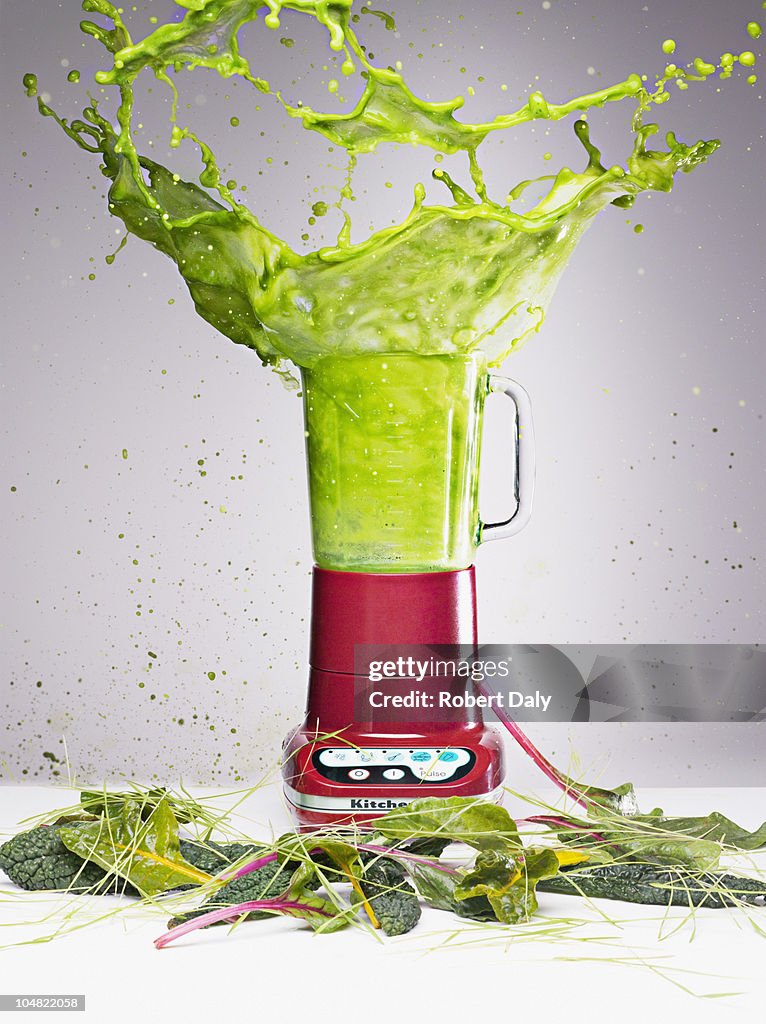 Vegetable juice splashing from blender