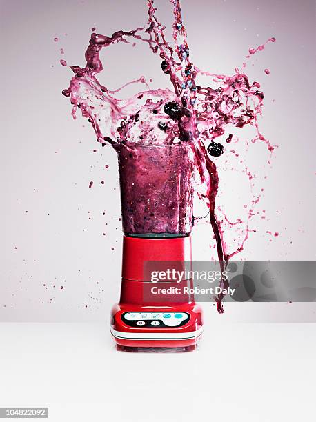 blueberry juice splashing from blender - smoothie bildbanksfoton och bilder