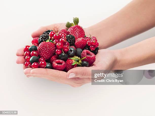 woman holding berries - handful stock pictures, royalty-free photos & images