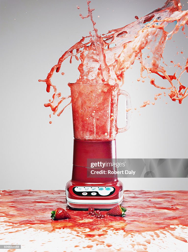 Berry juice splashing from blender