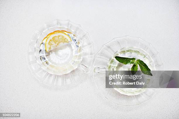 orange wedge and mint sprig in glasses of water - cup of tea from above stock pictures, royalty-free photos & images