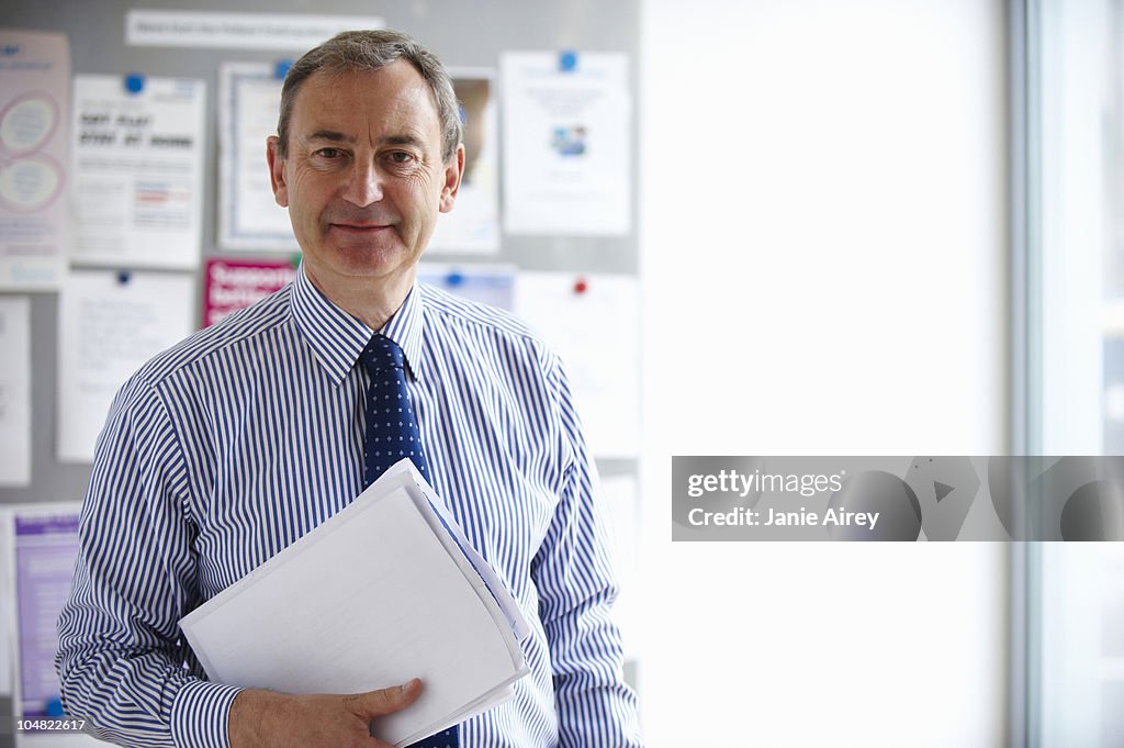 Male Medical consultant holding papers