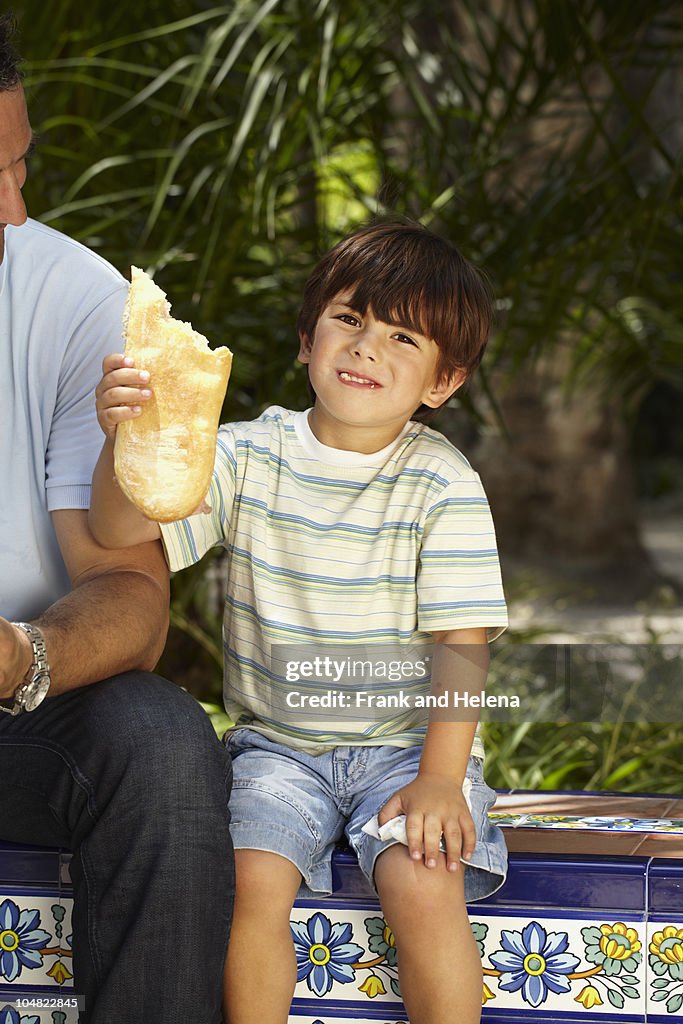 Boy holding piece of bread