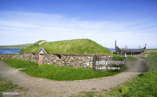 Reconstruction of Norse Viking longhouse and the Skidbladner, full size replica of Gokstad ship at Brookpoint, Unst, Shetland Islands, Scotland, UK.