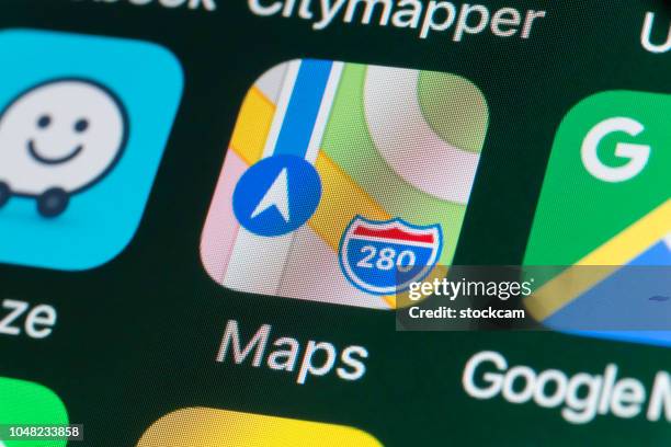 apple maps, google maps, waze and other apps on iphone screen - apple computers imagens e fotografias de stock