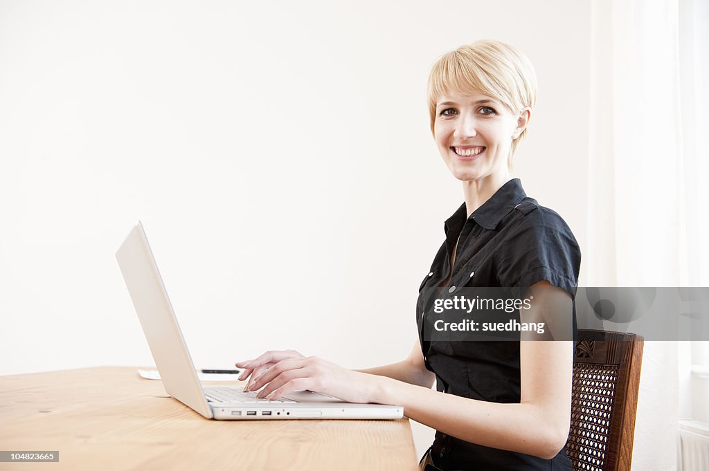 Young female using a laptop at home