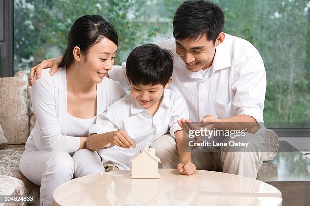 family saving for new home - all asian currencies stock pictures, royalty-free photos & images