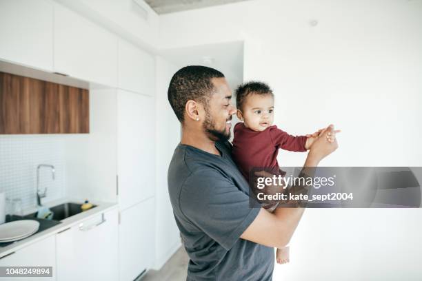 raising a child - father baby stock pictures, royalty-free photos & images