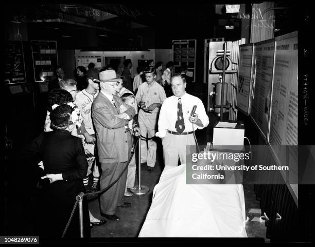 Atomic exhibition, 21 June 1952. Mary Howard - 15 years ;Mrs Sam Williams;Tom Mawhinney ;Jack Aldridge .;Caption slip reads: 'Photographer: Mitchell....