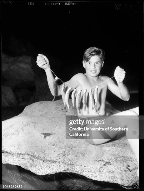 State beach grunion, 26 June 1952. Richard Fitch -- 12 years with 8 grunion he caught.;Caption slip reads: 'Photographer: Gaze. Date: . Reporter:...