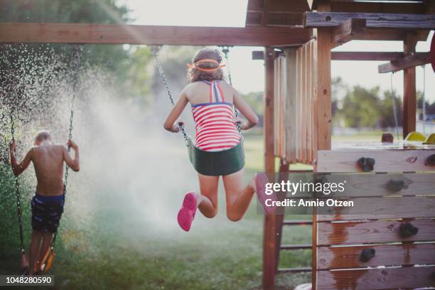 kids playing on backyard swing set - backyard swing set stock pictures, royalty-free photos & images