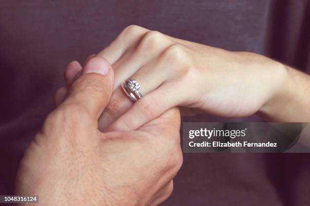 holding hands with engagement ring - heiratsantrag stock-fotos und bilder
