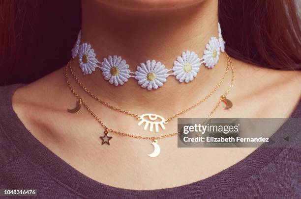 midsection of woman wearing choker and necklaces - collares fotografías e imágenes de stock