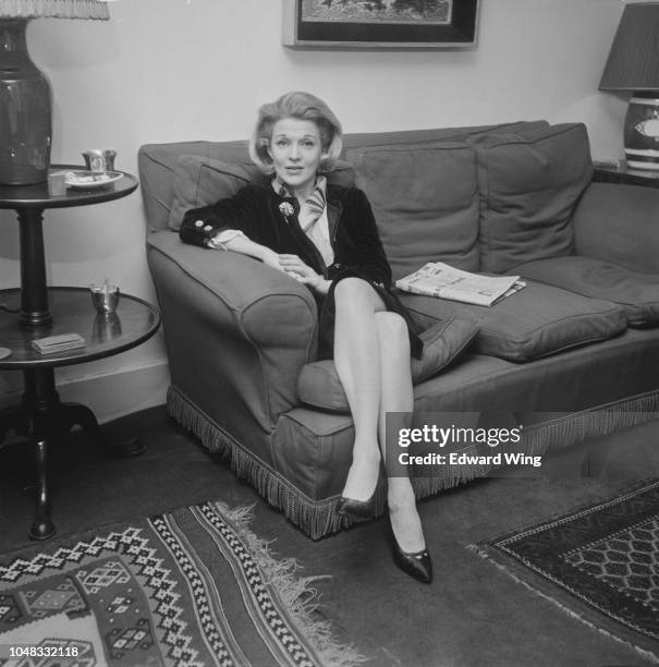 American singer and actress Marti Stevens pictured seated on a sofa in London on 30th April 1963.