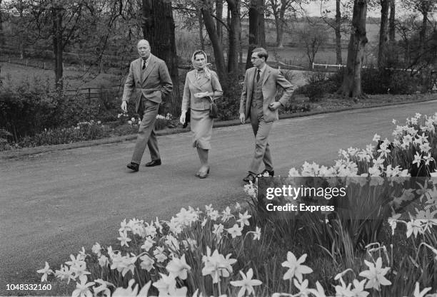 Prince Henry, Duke of Gloucester pictured on left with Princess Alice, Duchess of Gloucester and their son Prince Richard walking along a drive in...