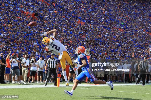 Justin Jefferson of the LSU Tigers attempts a reception while being defended by CJ Henderson of the Florida Gators during the game at Ben Hill...