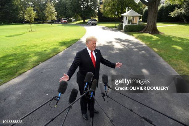 President Donald Trump talks to the press as leaves the White House by the South lawn and boards Marine One en route to Council Bluffs, Iowa, for a...