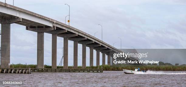 Boat runs under the Apalachicola River bridge prior to the arrival of Hurricane Michael on October 9, 2018 in Apalachicola, Florida. The hurricane is...