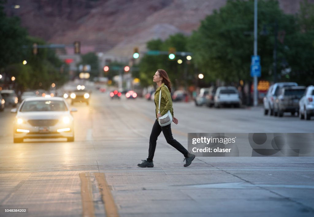 アメリカの小都市交通横断道路、背景の山の女